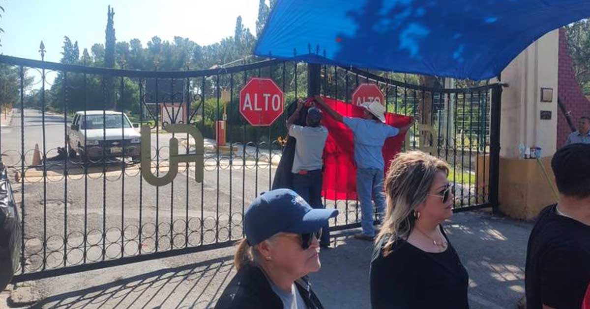 Trabajadores quitan las banderas rojinegras