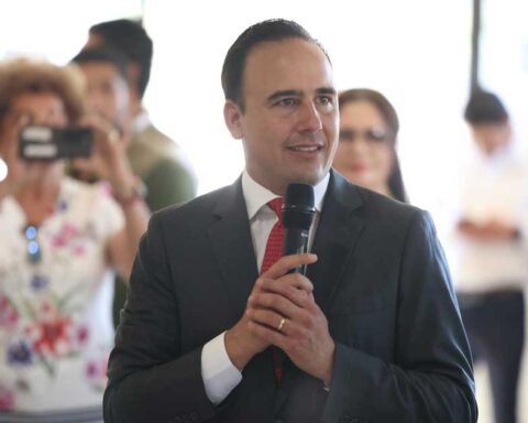 El gobernador de Coahuila Manolo Jiménez sosteniendo un micrófono.
