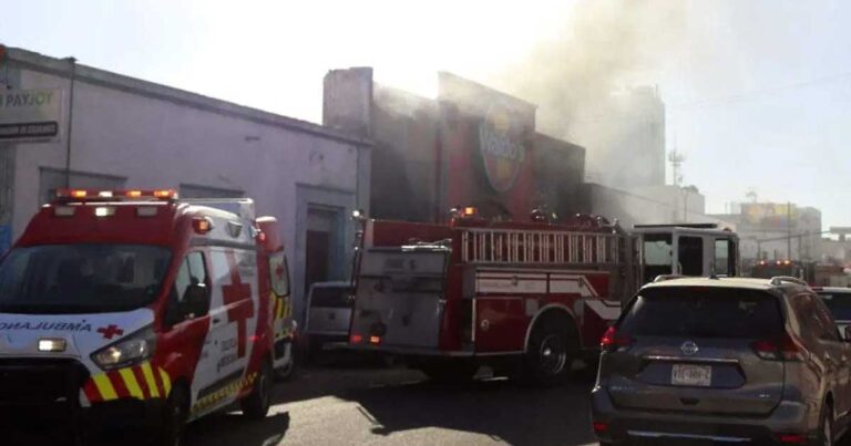 Exterior de la tienda Waldos y bomberos atendiendo el incendio.