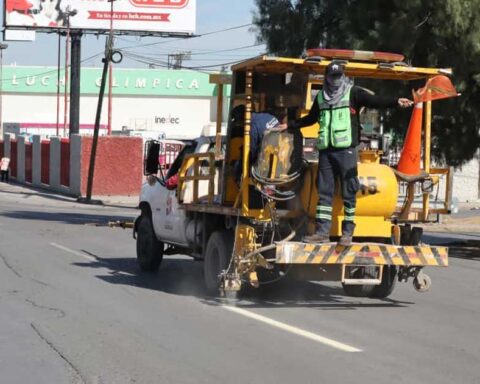 Hombres en maquinaria delimitando carriles de Saltillo.