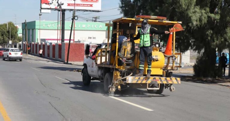 Hombres en maquinaria delimitando carriles de Saltillo.