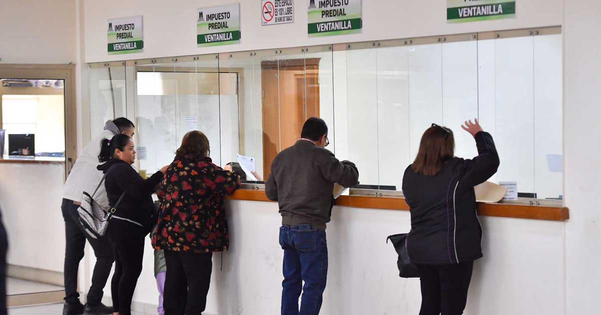 Contribuyentes pagando el predial en las ventanillas.