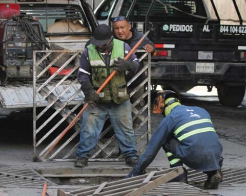 Trabajadores reparando rejillas pluviales en Saltillo.