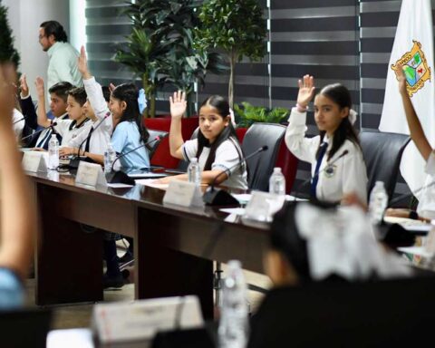 Integrantes del Cabildo Infantil aprobando levantando la mano en sesión en Torreón.