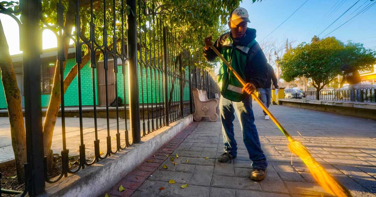 Trabajador de Ramos Arizpe barriendo una banqueta.